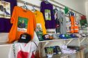 Branded T-shirts, baseball caps and notebooks with images of Nigerian presidential candidates are displayed at a shopping center in Abuja