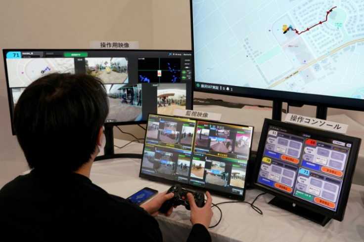 An employee at a control centre monitors Panasonic delivery robots using a live feed from remote cameras at the Fujisawa Sustainable Smart Town in Fujisawa, Kanagawa Prefecture