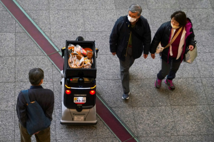 Test runs so far have ranged from delivering medicine to peddling snacks in Tokyo, with disarming patter such as: 'Another cold day, isn't it? How about some hot drinks?'