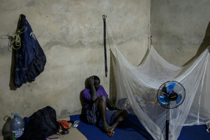 A migrant worker in the room he shares with fellow West Africans