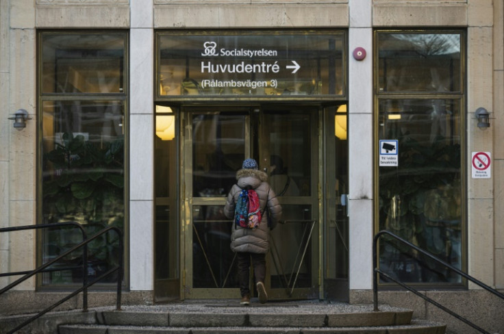 A woman enters the headquarters of the National Board of Health and Welfare, in Stockholm