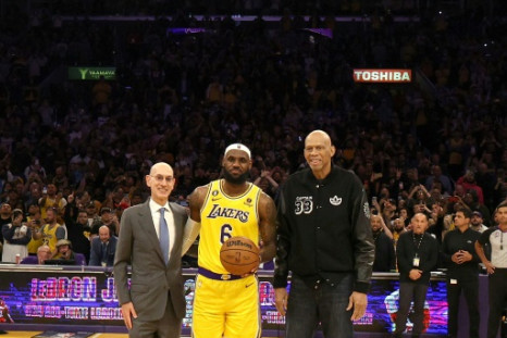 NBA Commissioner Adam Silver, LeBron James and Kareem Abdul-Jabbar stand on court after James became the NBA's all-time leading scorer on Tuesday