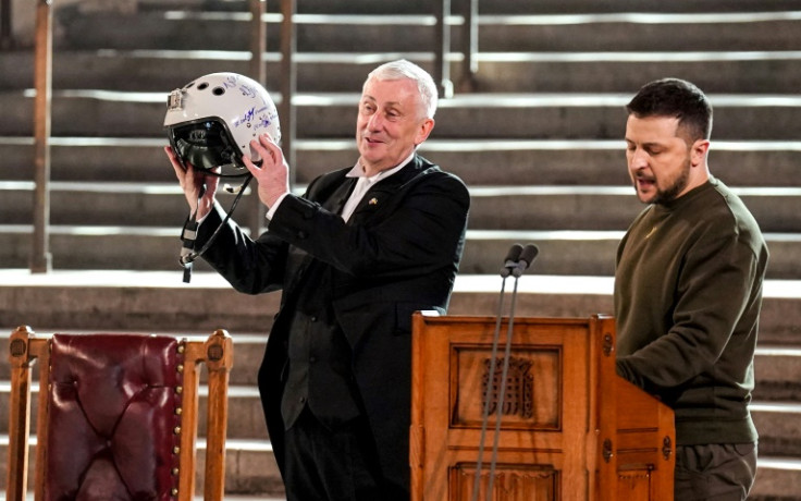 Speaker of the House of Commons Lindsay Hoyle holds aloft a Ukrainian air force ace's helmet presented by President Volodymyr Zelensky