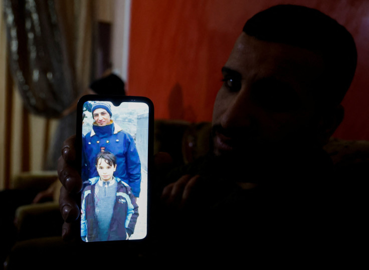 A relative of a Palestinian man, Abdel-Karim Abu Jalhoum, who died with his family in the earthquake in Turkey, shows his picture on a phone, in Beit Lahiya in northern Gaza Strip