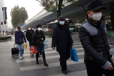 People cross a road amid the coronavirus disease (COVID-19) outbreak, in Wuhan