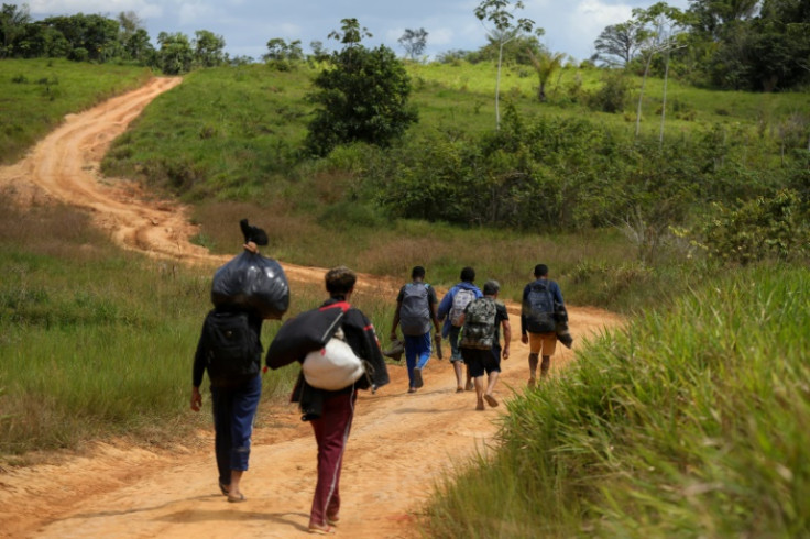 Alleged illegal miners leave a mining area inside Yanomami indigenous land