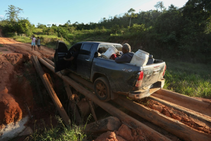 Alleged illegal miners leave an illegal mining area inside Yanomami indigenous lands