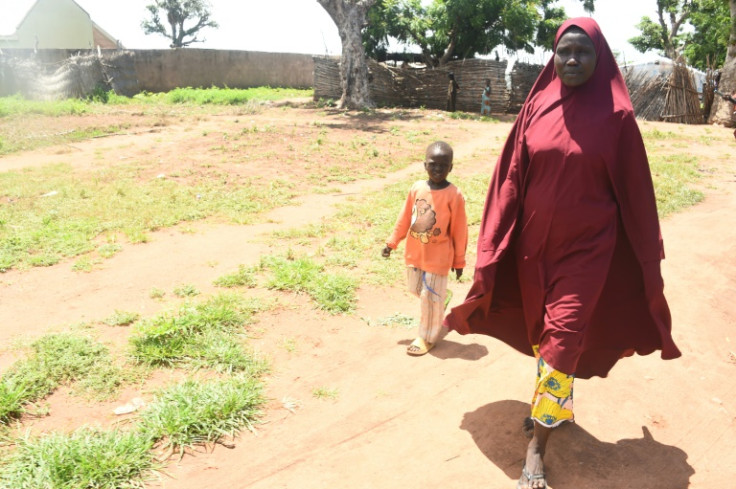 Hafsatu Usman and her son, Yusuf, five, who follows his mother everywhere, in their camp in Yola