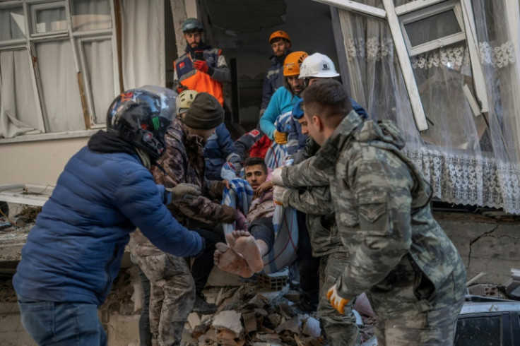 Rescuers carry a man after days trapped in Turkey's quake-hit southeastern province of Hatay