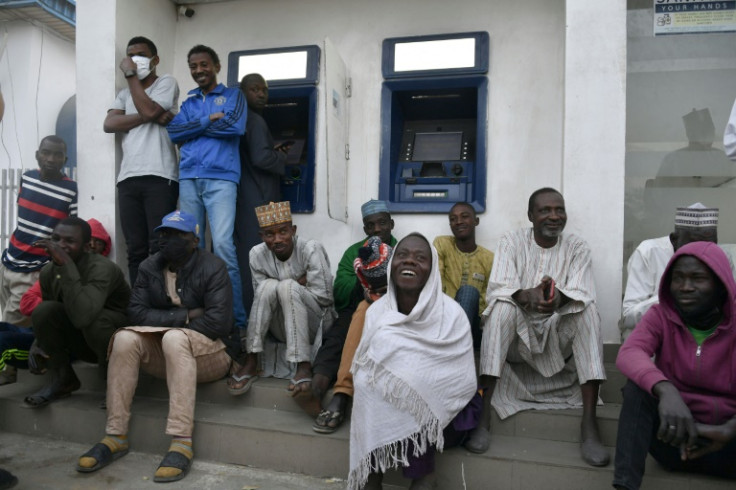 Kano residents wait before dawn to sign up for a chance to withdraw small amounts of cash