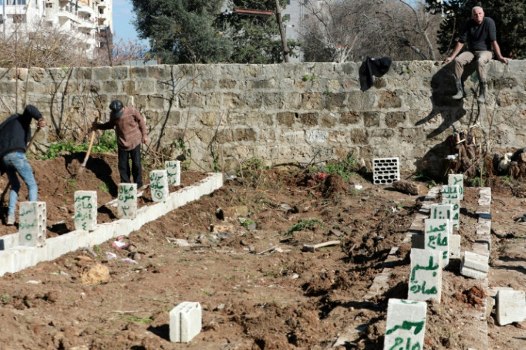 Graves are dug for earthquake victims in Jableh, a city in Syria's Latakia province