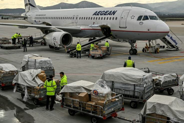 Staff load medical supplies near Athens, as part of Greek aid to Turkey