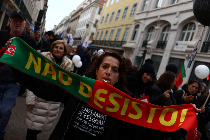 A school teacher holds a scarf saying "I don't quit" as part of a teachers' demonstration for better salaries and working conditions in Lisbon