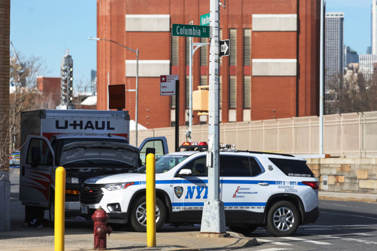 A New York Police Department vehicle blocks a U-Haul rental vehicle, in the Brooklyn borough of New York City