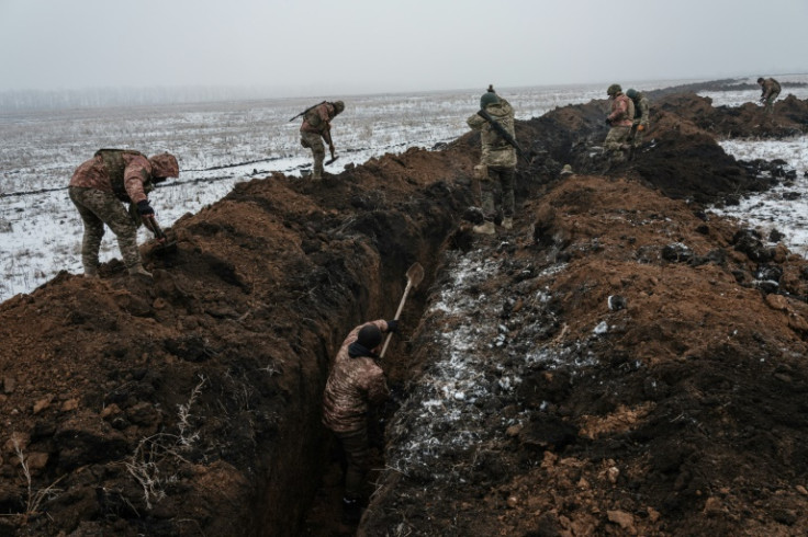 Ukrainian servicemen dig a trench near Bakhmut on February 1, 2023