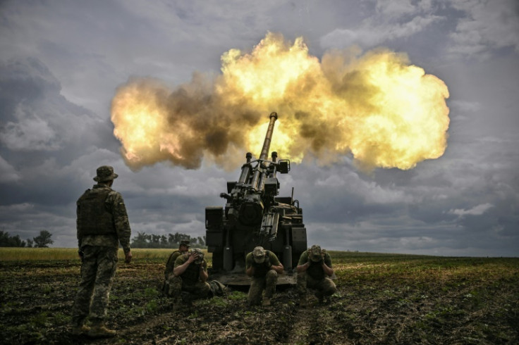 Ukrainian servicemen fire a French self-propelled Caesar howitzer