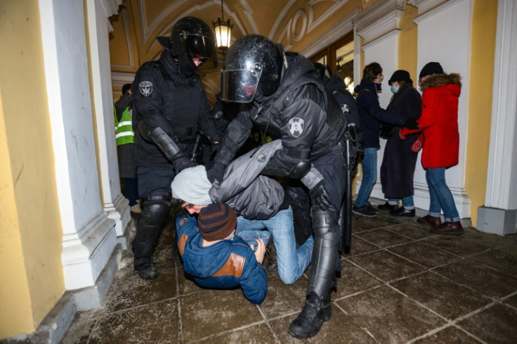 Russian police detain a demonstrator during a protest against Russia's invasion of Ukraine in central Saint Petersburg on February 24, 2022