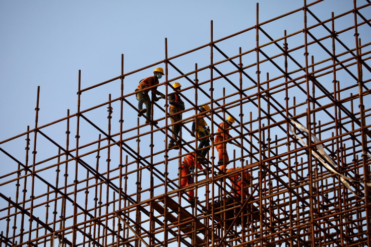 Construction workers work on the country's first metro-rail project in Dhaka