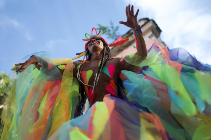 A reveler dances on stilts at the 'Heaven on Earth' carnival street party, one of hundreds held across Rio