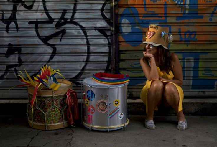 A reveler takes a break during a carnival street party in Rio de Janeiro