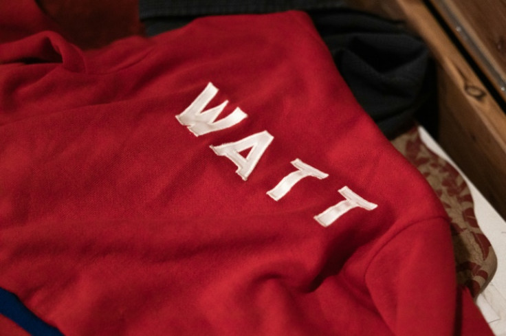 Jessica Watt lays out a sweater belonging to her late father, Randy Watt, at her home in Bellaire, Ohio