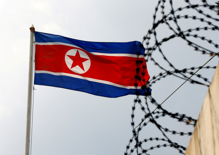 A North Korea flag flutters next to concertina wire at the North Korean embassy in Kuala Lumpur