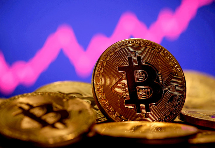 A representation of virtual currency Bitcoin is seen in front of a stock graph in this illustration taken