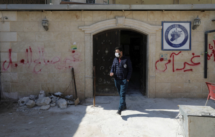 A man walks at the entrance of a hospital which is supported by Syrian American Medical Society (SAMS) and was damaged by the deadly earthquake earlier this month in al-Dana town at rebel-held Idlib