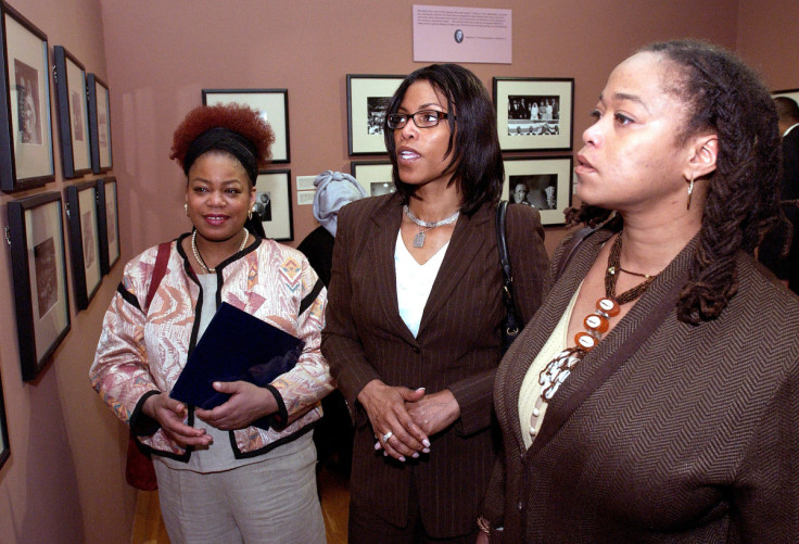 Daughters view photographs at the opening of an exhibition about Malcolm X in New York.