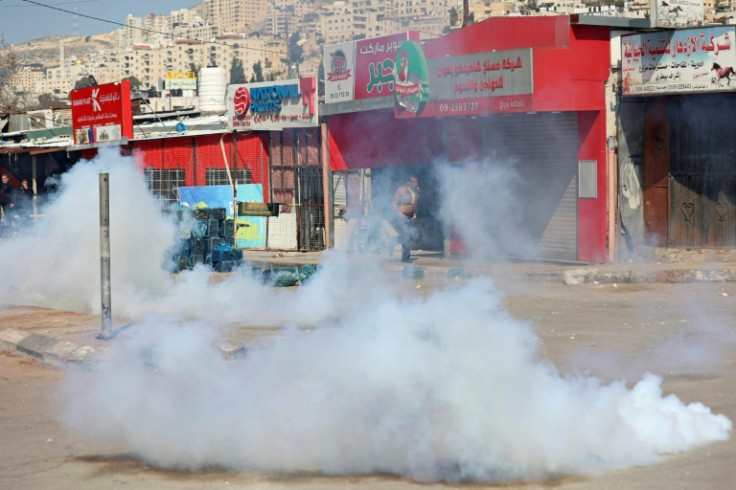 Israeli security forces fire tear gas during a deadly raid in the flashpoint West Bank city of Nablus