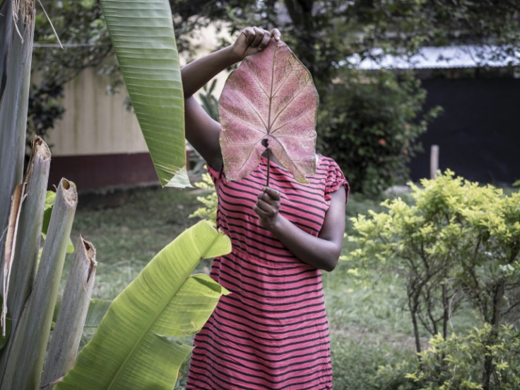 Rape epidemic: A 15-year-old victim of sexual assault in the Central African Republic hides her face behind a large leaf