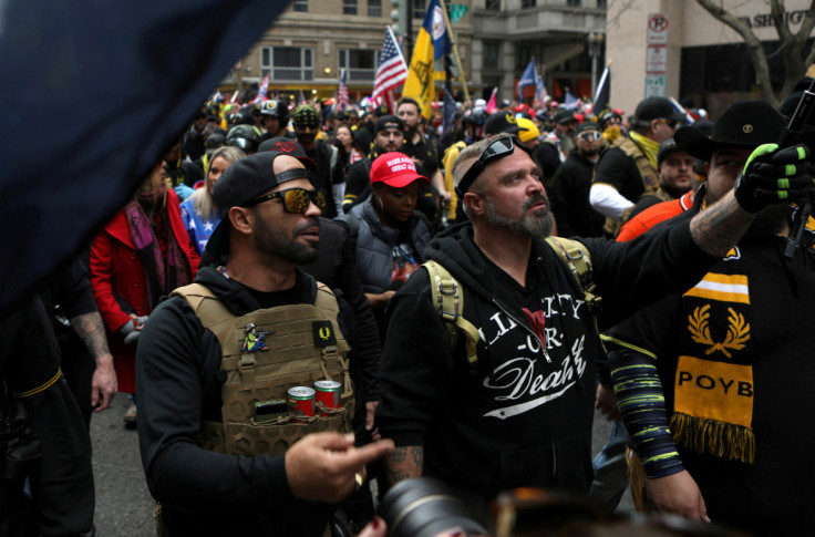 Proud Boys members Enrique Tarrio and Joe Biggs march