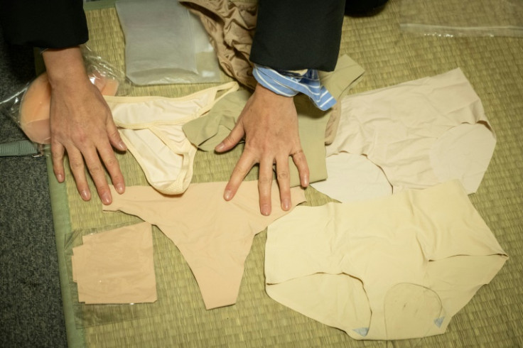 Momoko Nishiyama displays the contents of a bag of underwear she takes to work on set