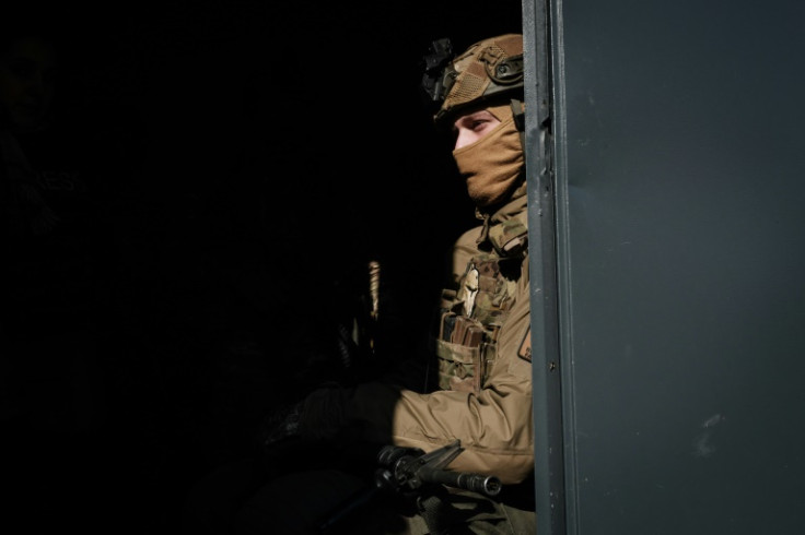 A Ukrainian serviceman waits for an order to fire an anti-tank grenade launcher, near Bakhmut on the first anniversary of the Russian invasion