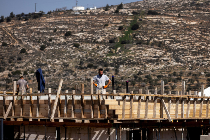A construction worker stands on a building site in the Jewish settlement of Givat Harel in the Israeli-occupied West Bank