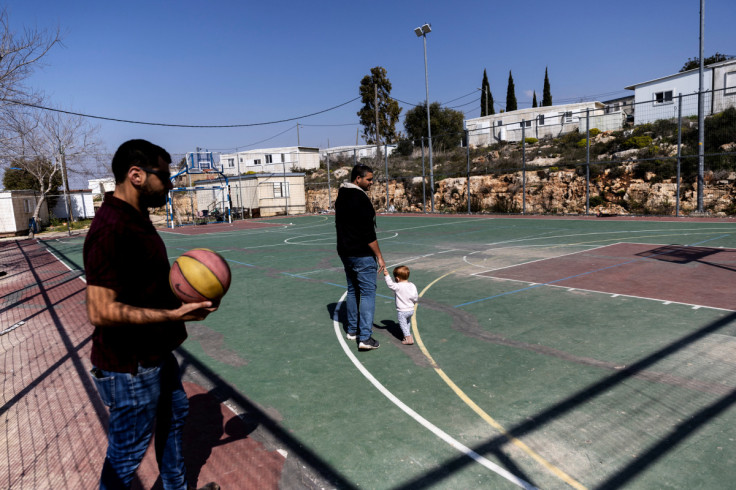 Avichai holds a ball at a basketball court in the Jewish settlement of Givat Harel in the Israeli-occupied West Bank