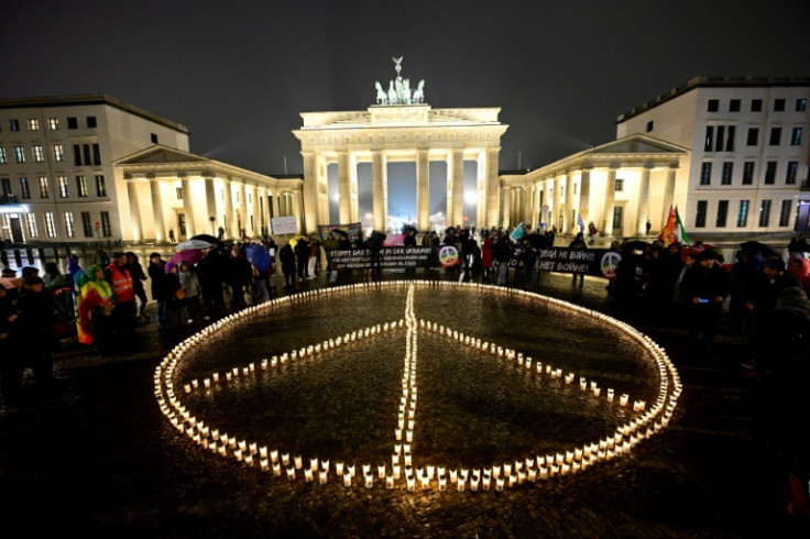 A giant peace sign is formed with candles in front of the Brandenburg Gate in Berlin