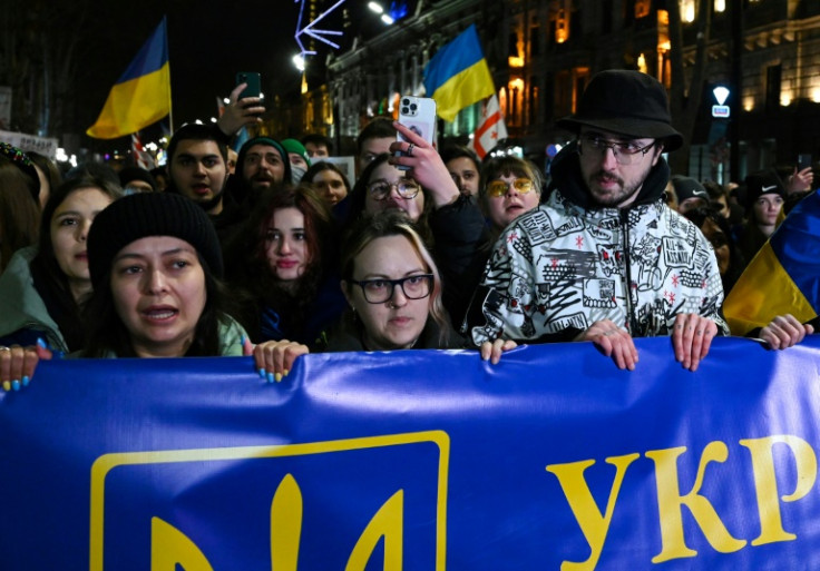 Demonstrators gathered outside parliament waving Georgian, Ukrainian and EU flags in solidarity with Ukraine on the first anniversary of Russia's invasion