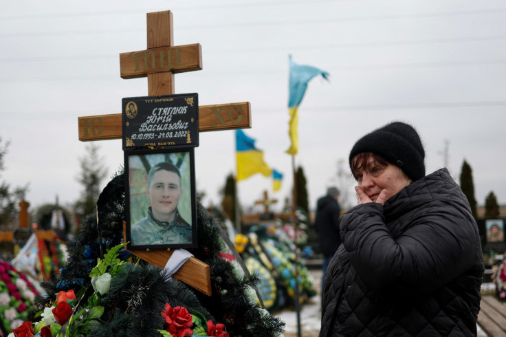 People visit graves of their ralatives in the town of Bucha