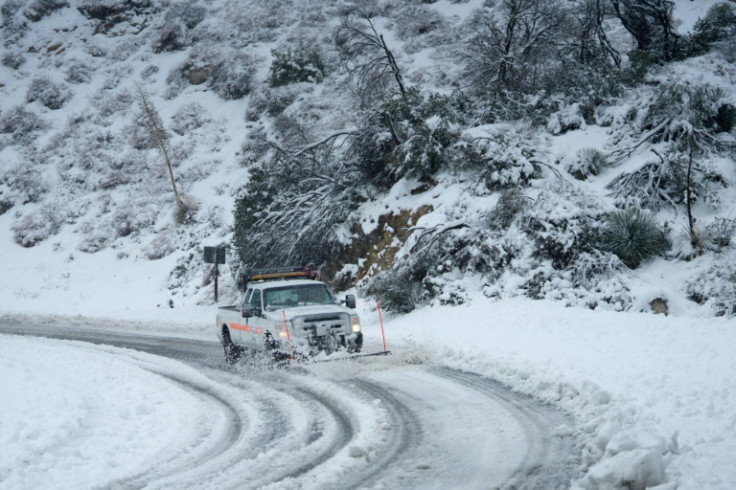 Snow has snarled mountain roads around sothern California, as a brutal, but unusual, winter storm grips the area
