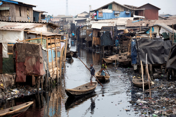 Boys row a boat in Makoko, Lagos