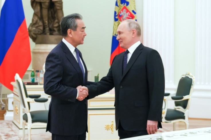 Russian President Vladimir Putin (R) meets with China's top diplomat Wang Yi at the Kremlin on February 22, 2023, underscoring the close ties between their nations at a moment of geopolitical tensions over the war in Ukraine