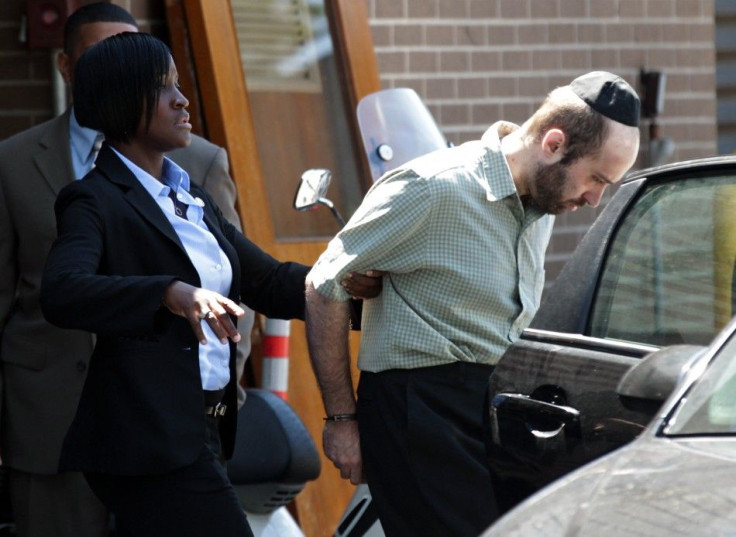 Murder suspect Levi Aron is escorted out of a New York Police Department precinct in Brooklyn