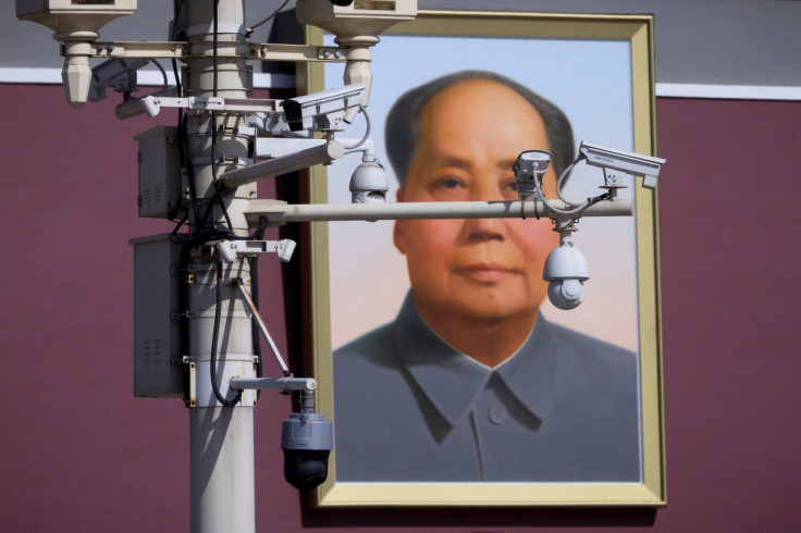 Surveillance cameras overlook Tiananmen Square in front of a portrait of late Chinese chairman Mao Zedong, ahead of the opening of the National People's Congress (NPC) in Beijing