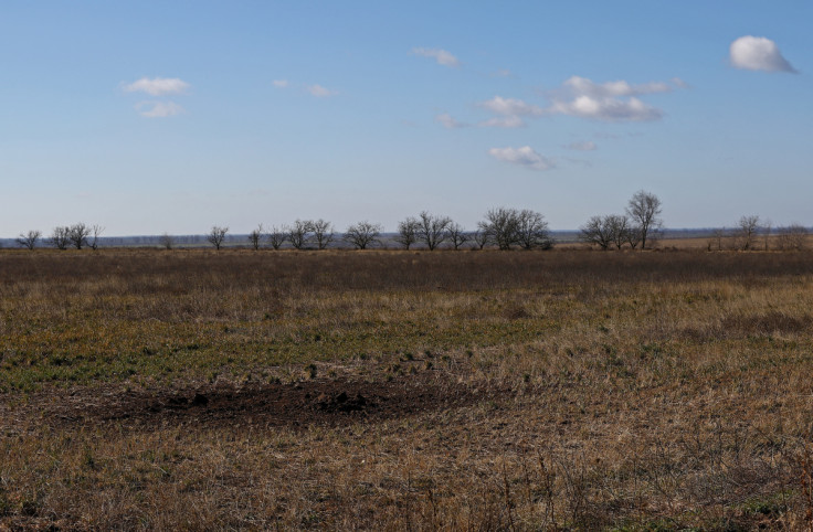 A view of the depression from shelling in field of grain farmer Andrii Povod that has been damaged by shelling and trenches, in Bilozerka