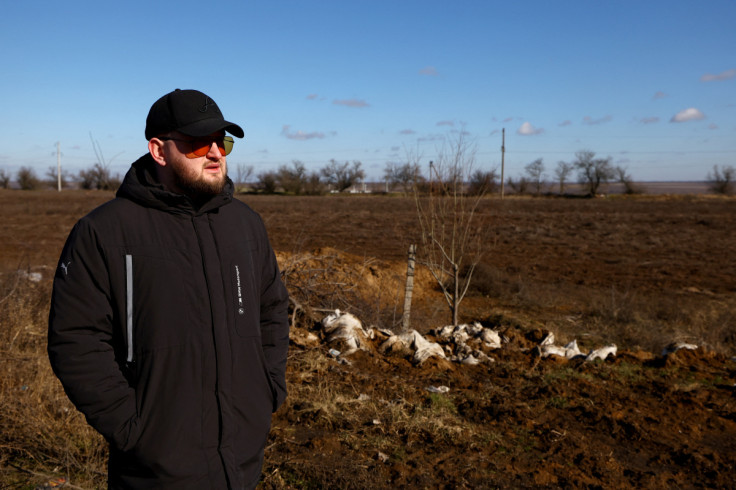 Grain farmer Andrii Povod stands beside his field that has been damaged by shelling and trenches, amid Russia's invasion of Ukraine, in Bilozerka