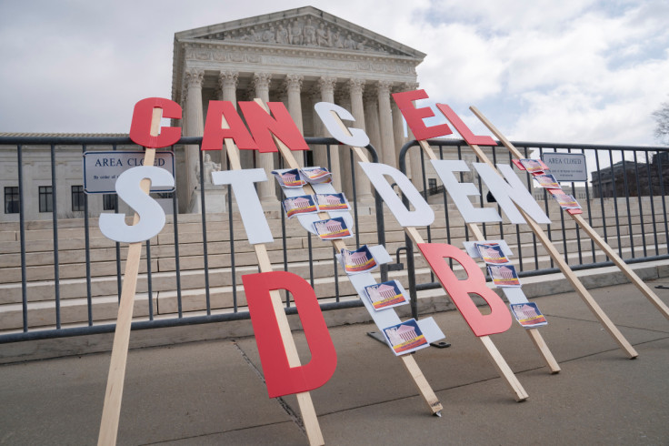 A sign calling for student loan debt relief is seen in front of the Supreme Court