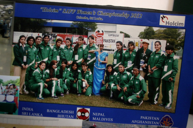 A group photo of a soccer team that includes Pakistan women's hockey player Raza is displayed for media at her home in Quetta