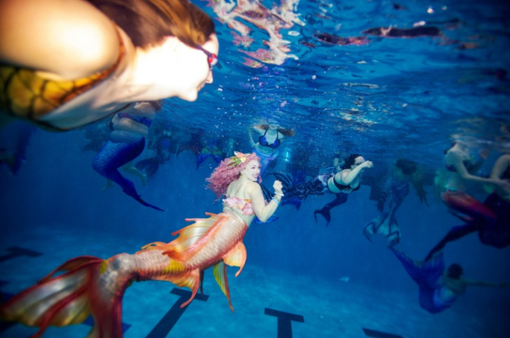 People in elaborate costume swim during what is billed as the world's largest mermaid gathering, the MerMagic Con from March 3 to 5, 2023 in the US state of Virginia