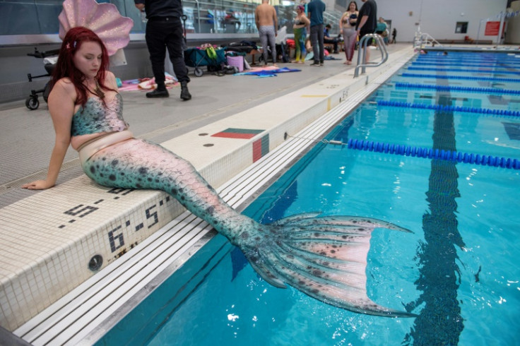 Like a fish out of water, Helena McLeod rests poolside; while she used to swim freely as a mermaid, a nerve-damaging condition has made it more difficult so she says she lives as a 'dry' mermaid
